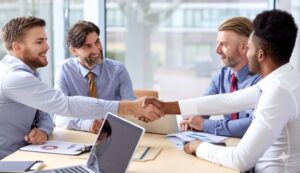 group of professionals shaking hands at an office setting
