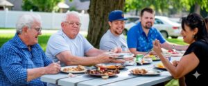 residents enjoying barbecue lunch at community park