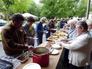neighborhood residents enjoying a community lunch at a public park