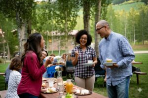 residents enjoying community picnic outdoors held by hoa management company