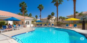 a well-maintained community pool at a desert neighborhood clubhouse