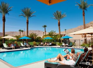 residents lounging by the community pool in a desert residential area