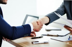 Durango HOA board representative shaking hands with employee from HOA Management Company