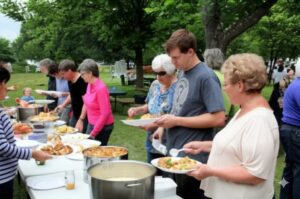 people having a good time at a neighborhood picnic held by hoa