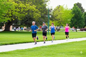 people jogging through a community HOA park in Boise