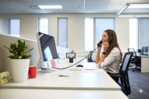 professional female answering phone calls at an office setting