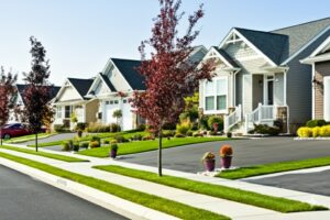 clean, orderly suburban street with similar-style houses and landscaped yards, representing a well-regulated community in Colorado Springs