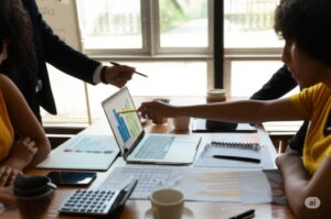 financial meeting with laptops showing charts, calculators, and spreadsheets on the table